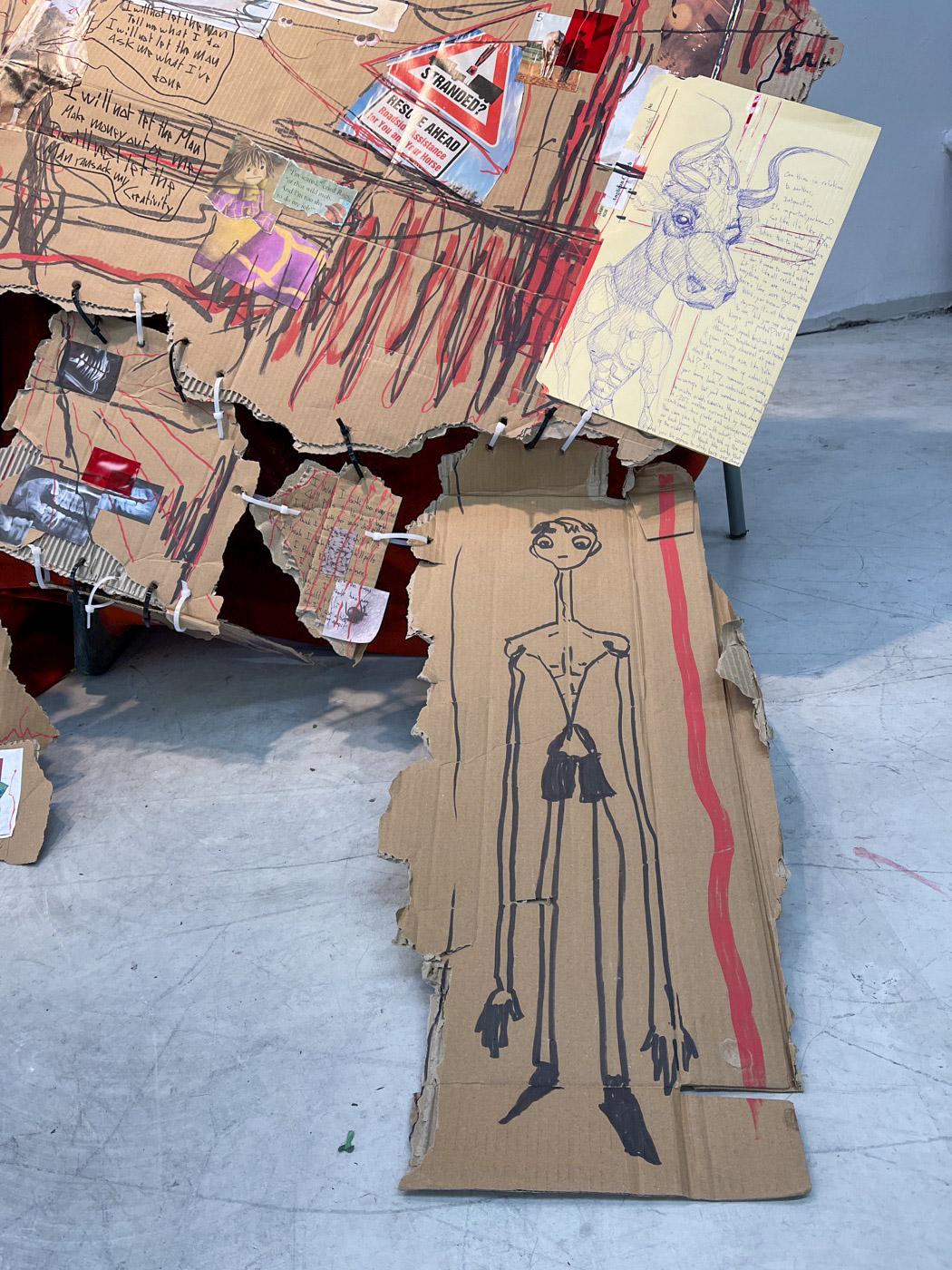 Layered cardboard figures, drawings and cable-tie joins from cuts/stitches