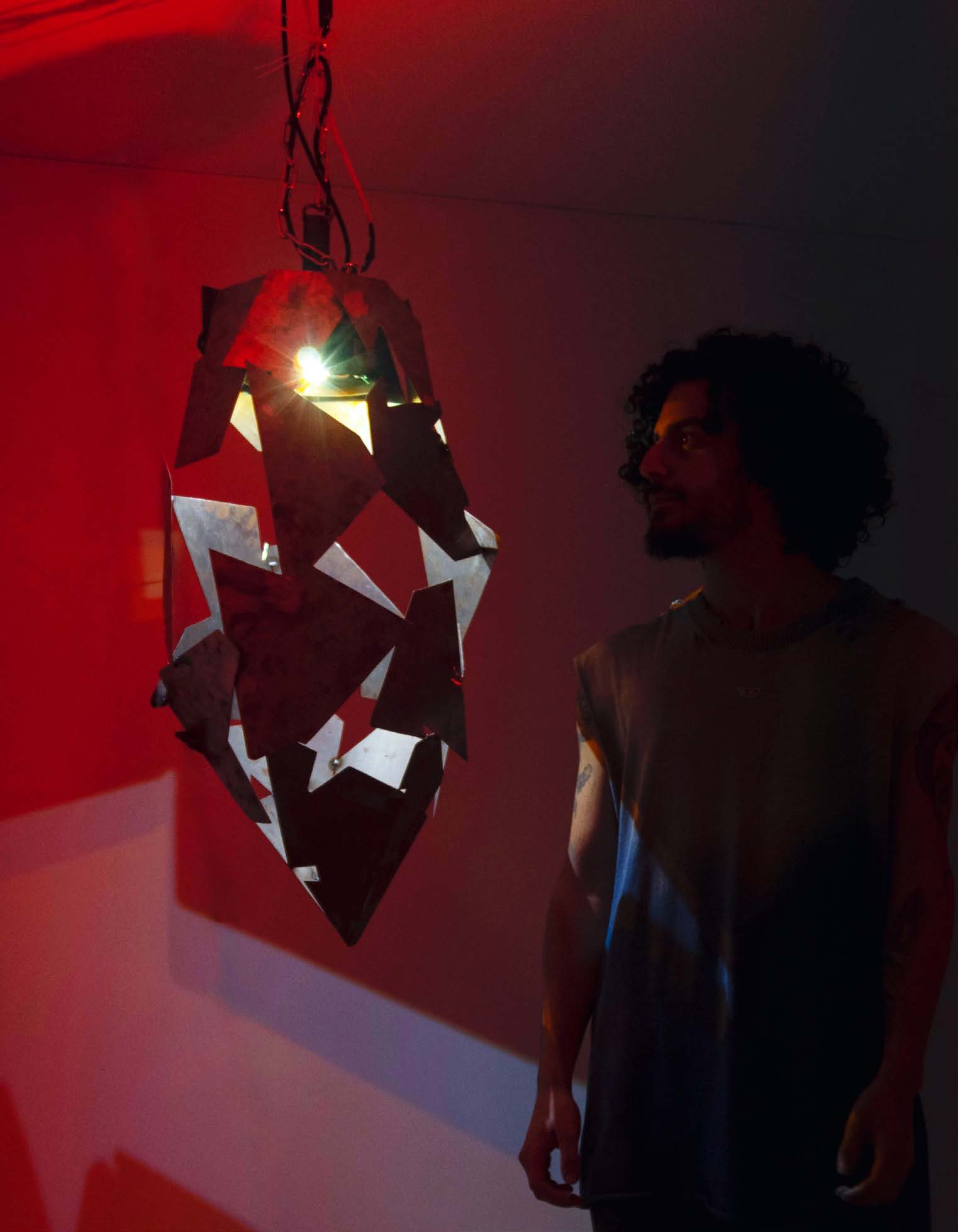 Sam Hoyek beside the illuminated sculpture in love_